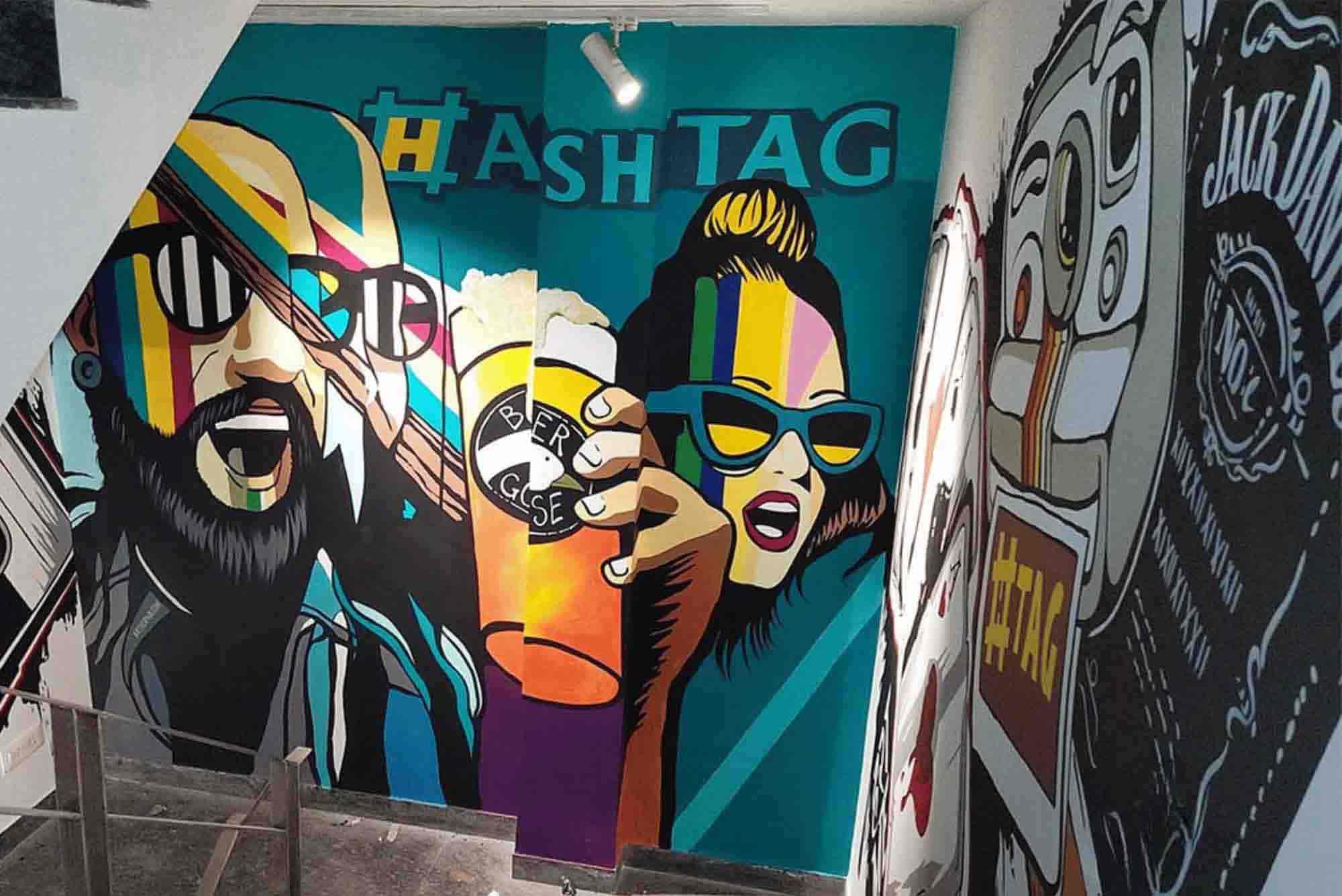 Vibrant graffiti mural with abstract faces and colorful accents on a stairwell wall, showcasing Graffiti Art Services in Gurgaon.