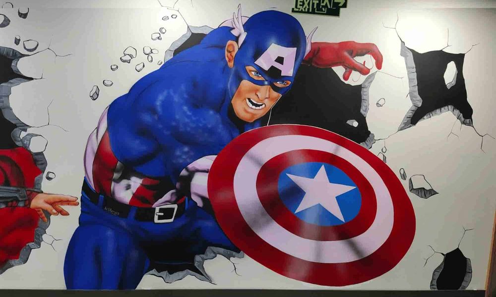 This stunning 3D mural brings Captain America to life, making it appear as if he is walking across the wall with his iconic shield. Perfectly crafted with vibrant colors, realistic depth, and intricate detail, this Marvel-themed mural is a striking masterpiece for offices, bars, playgrounds, or any superhero-themed space.
