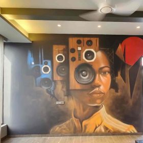 This video shows a beautiful image set to music. The film features human faces and large speakers replacing parts of a skull, creating a juxtaposition of characters and music. The façade is designed with precision and authenticity, and the speakers and subtle geometric shapes, such as red circles and knobs, create a classic and vintage look. The colors used on the walls, such as earth tones and the blue and brown of the speakers, create a great contrast. The film explores the relationship between music and personality, making it the perfect urban street art for any modern space.