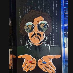 This image features a captivating graphic design inspired by the famous scene from the movie The Matrix. This drawing shows a character holding two pills, one red and one blue, representing the choice between reality and fantasy, as seen in the movie. The image is wearing large sunglasses with reflections of other characters in the eye sockets. In the background, a stream of digital code is transmitted, representing the virtual world of The Matrix, adding to the broadcast air. The character has a strong and iconic presence, with a bold and structured narrative that captures the movie's relevance in pop culture. Urban wall art brings a modern and unconventional twist to this popular movie.